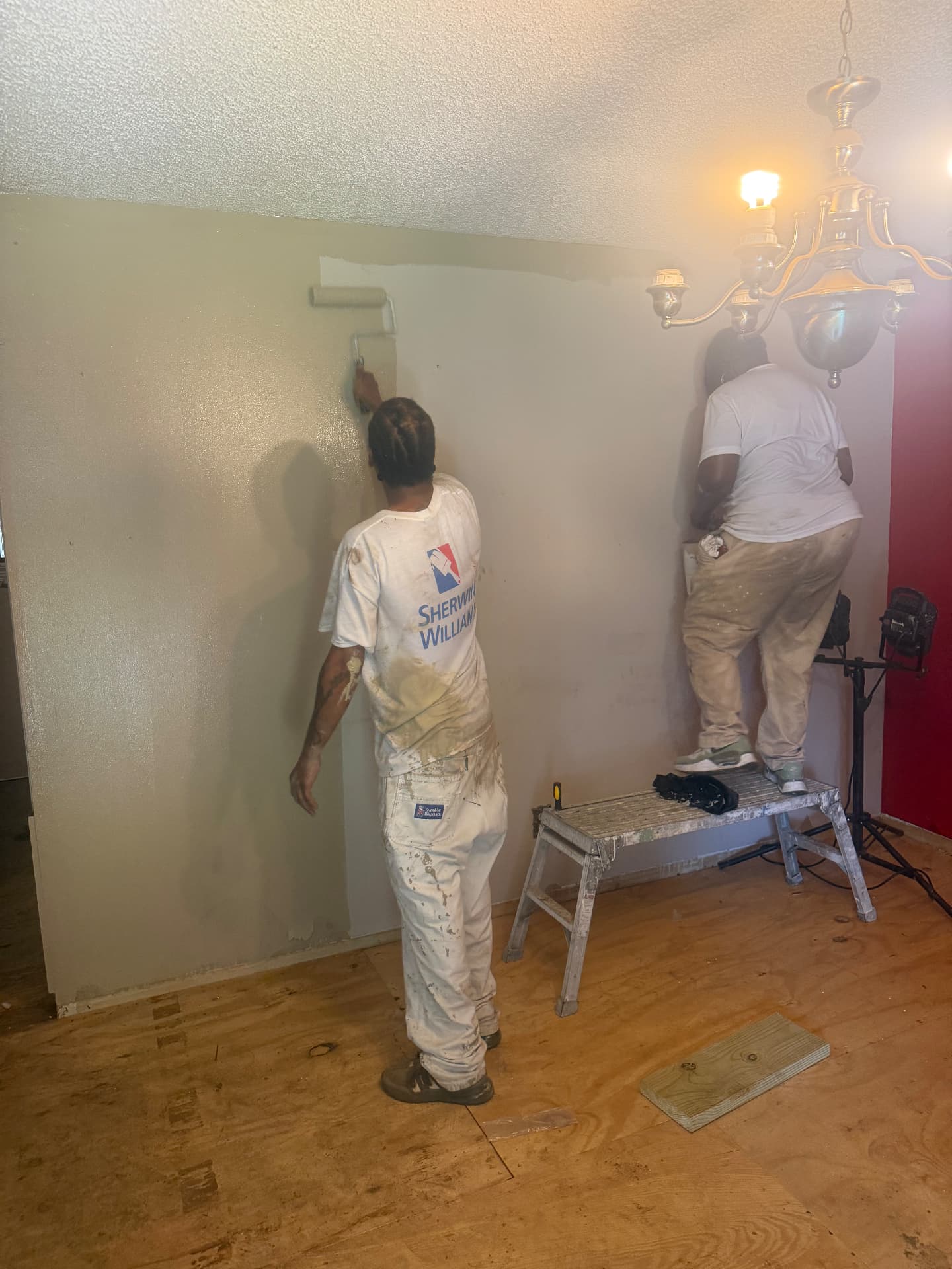 Team painting an interior dining room together during training